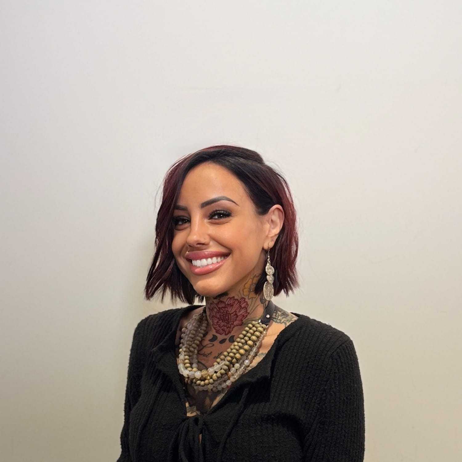 Portrait of Mia Urban, a professional stylist at The Maven and The Muse, showcasing their expertise and style.